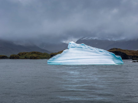 Antarctic iceberg and storm clouds at Stromness Harbour on South Georgia Island in Antarcticaの写真素材