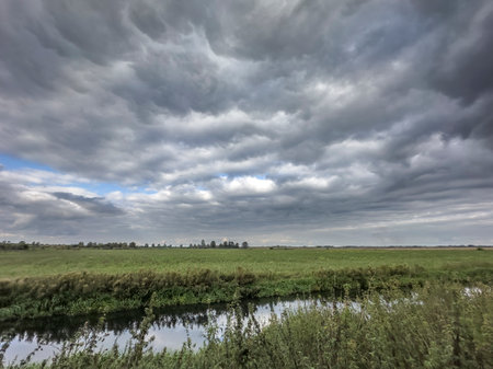 Mammatus clouds forming over a fenland scene and agricultural landscape in Farcet Fen, Cambridgeshire, Englandの写真素材