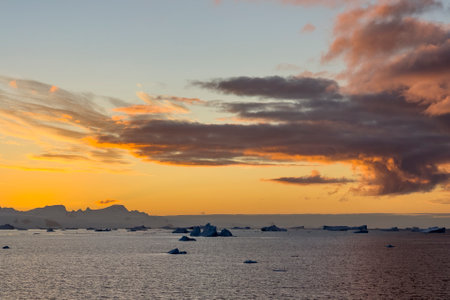 Sunset over Trinity Island in the Antarctic Peninsula, Antarcticaの写真素材