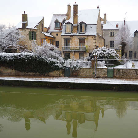 snowy houses on the towpath of the Briare canal in Montargis