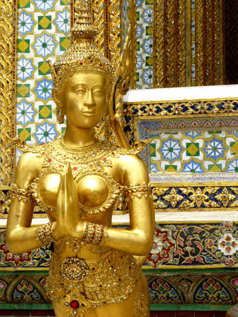 Golden Kinnari statue at Wat Phra Kaew, Grand Palace, Bangkok, Thailand