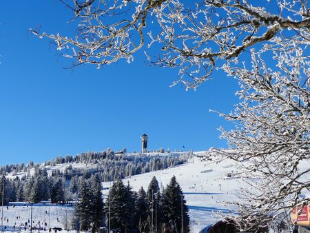 View of the television tower and ski slopes of the Feldberg, Black Forest, Germanyの写真素材
