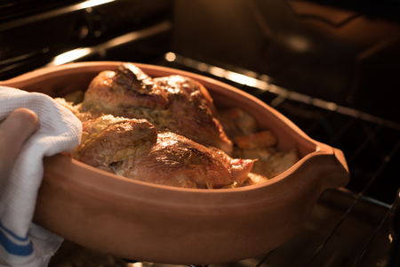 Chicken baked in Oven in a Clay Dishの写真素材