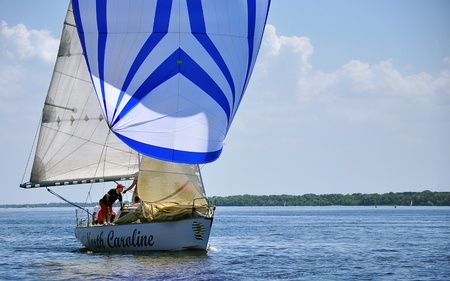 Zaporozhye City, Ukraine - June 13, 2010 - A yachtsman standing on the boat during a regatta on the river Dnieperのeditorial素材