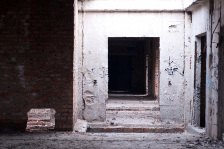 Old brick abandoned building interior with some graffiti on the wallsの写真素材