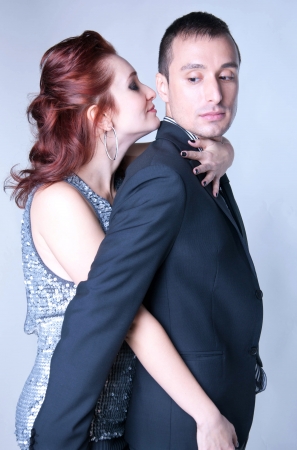 Studio portrait of sensual copule a man and a woman dressed in elegant clothesの写真素材