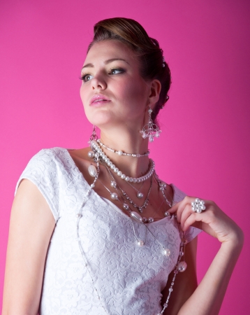 beautiful young brunette bride all in white wearing white wedding dressの写真素材