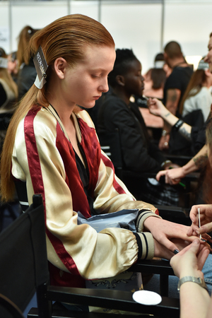 SYDNEY / AUSTRALIA - 20 May: Model is getting ready and being done a hair and nails by a member of style team for show before House of Cannon fashiob show at Mercedes Benz Fashion Week Australia on 20 May 2016 in Carriageworks Sydneyのeditorial素材
