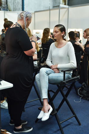 SYDNEY / AUSTRALIA - 20 May: Model is getting ready and being applied a makeup by a makeup artist for show before House of Cannon fashiob show at Mercedes Benz Fashion Week Australia on 20 May 2016 in Carriageworks Sydneyのeditorial素材
