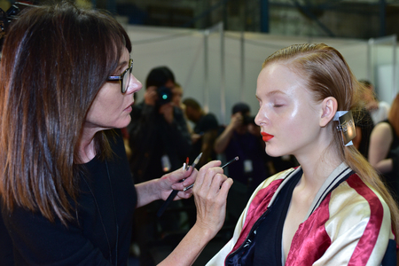 SYDNEY / AUSTRALIA - 20 May: Model is getting ready and being applied a makeup by a makeup artist for show before House of Cannon fashiob show at Mercedes Benz Fashion Week Australia on 20 May 2016 in Carriageworks Sydneyのeditorial素材