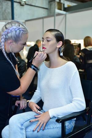 SYDNEY / AUSTRALIA - 20 May: Model is getting ready and being applied a makeup by a makeup artist for show before House of Cannon fashiob show at Mercedes Benz Fashion Week Australia on 20 May 2016 in Carriageworks Sydneyのeditorial素材