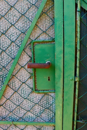 Old green garden gate with fence, detailの写真素材