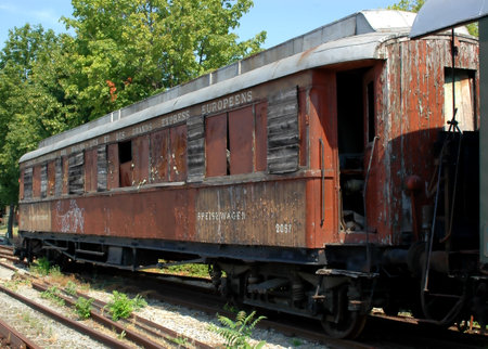 Old rusty wagons on the railroad tracks of the train station.の写真素材