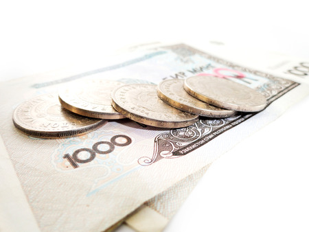 Cash denominations and coins. The Uzbek currency. Monetary unit of the Republic of Uzbekistan. On a white background.の写真素材