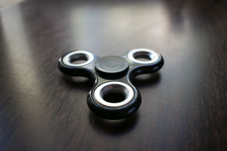 A toy for fun. Fun, have fun. Photo of a black spinner. For relaxation.の写真素材