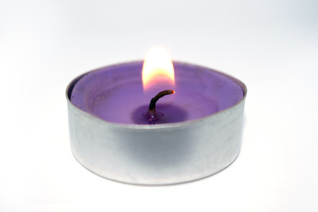 Photo of a small candle. Festive atmosphere, evening lighting. A photo on a white background.の写真素材