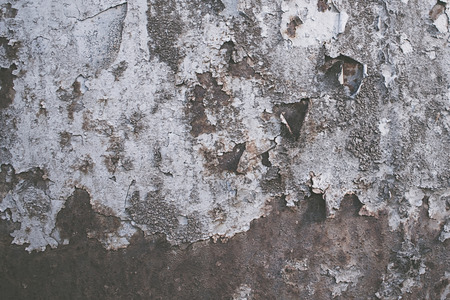 Photo texture tattered metal, relief. Rusty, iron plate with the remains of paint.の写真素材