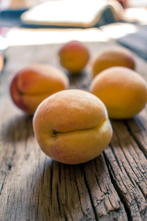Photo of apricots. On a wooden surface. Summer fruits.の写真素材