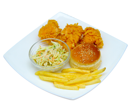Chicken nuggets with french fries, greens on a plate. On a white background.の写真素材