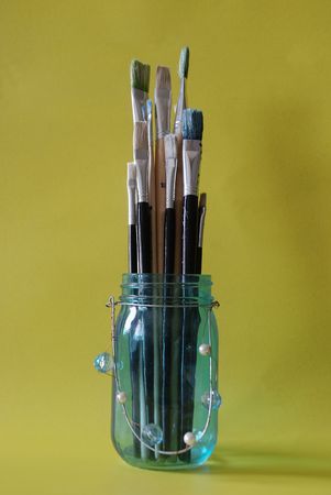 Paint brushes in a bottleの写真素材