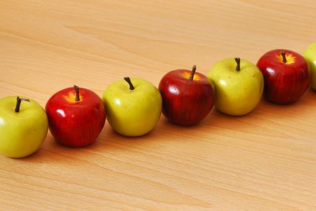 Row of green and red applesの写真素材