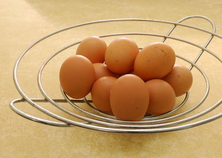 Eggs in a wire basketの写真素材