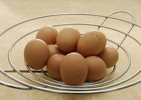 Eggs in a wire basketの写真素材