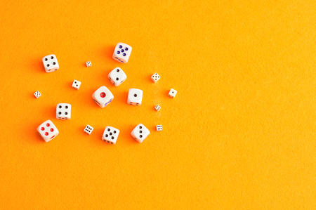 A collection of dice on an orange background