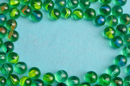 A border made out of marbles on a blue backgroundの写真素材