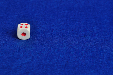 A dice that is displayed on a blue background