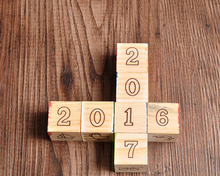 2016 2017 written with wooden blocks on wooden backgroundの写真素材
