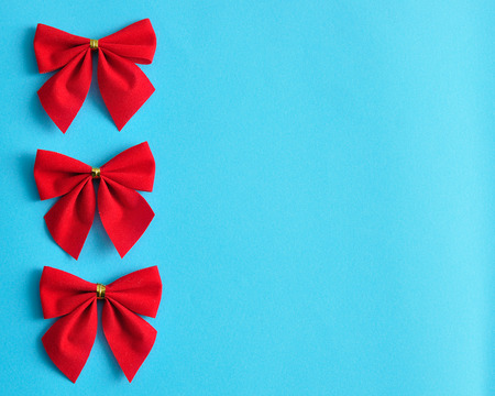 Red bows isolated on a blue backgroundの写真素材