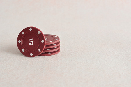 Red poker chips with the value 5 on itの写真素材