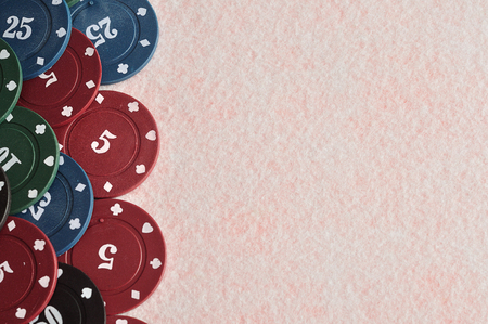 Poker chips forming a border on the left with a white backgroundの写真素材