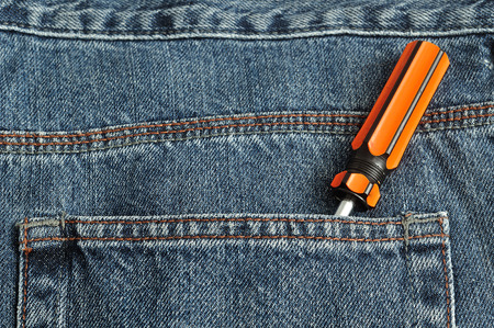 A screw driver in the back pocket of a denim jeans pantの写真素材