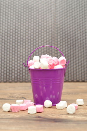 Pink and white marshmallows in a pink containerの写真素材