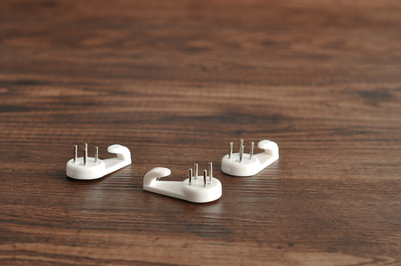 pins to hang portraits isolated on a wooden backgroundの写真素材