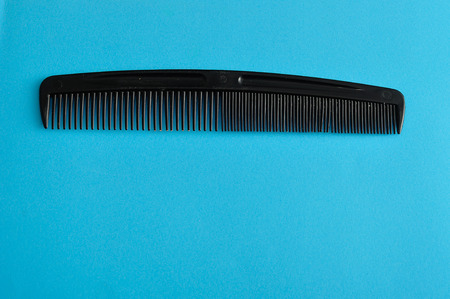 Comb isolated on a blue backgroundの写真素材