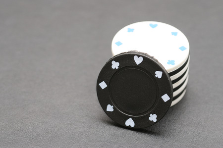 White and black poker chips on a black backgroundの写真素材