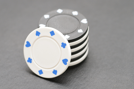 White and black poker chips on a black backgroundの写真素材