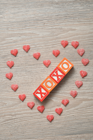 Valentine's Day. XOXO Spelled with colorful alphabet blocks with a candy heartの写真素材