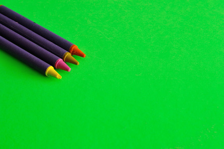 Wax crayons isolated on a green backgroundの写真素材