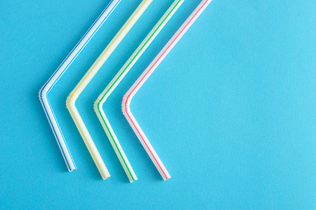 Bended drinking straws on a blue backgroundの写真素材