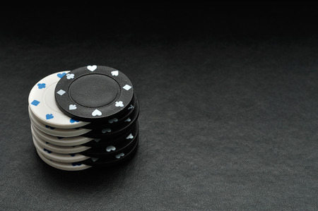 White and black poker chips on a black backgroundの写真素材