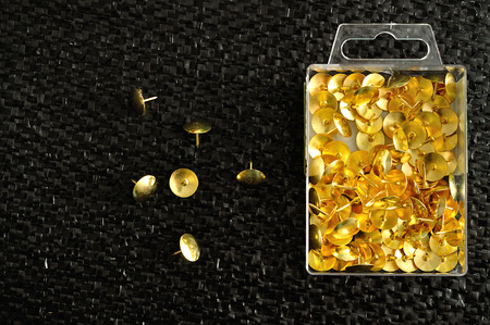 Thumb tacks in a container
