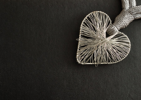 Valentine's Day. A heart made out of silver on a black backgroundの写真素材