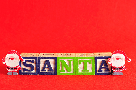 Two santa's with the word santa spelled with colorful alphabet blocksの写真素材