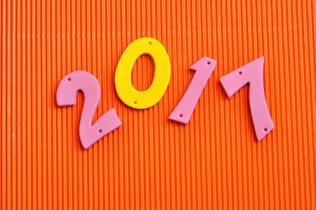 2017 in pink and yellow numbers isolated against an orange background