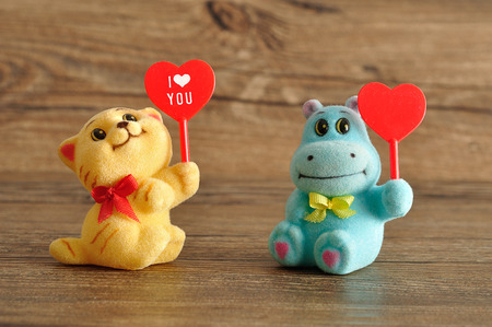 Valentine's day. Two figurines holding heartsの写真素材