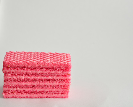 A stack of pink wafer biscuitsの写真素材